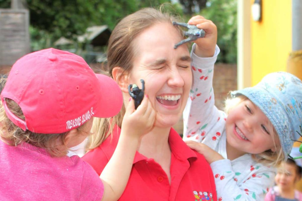 A supervisor playing with some young girls