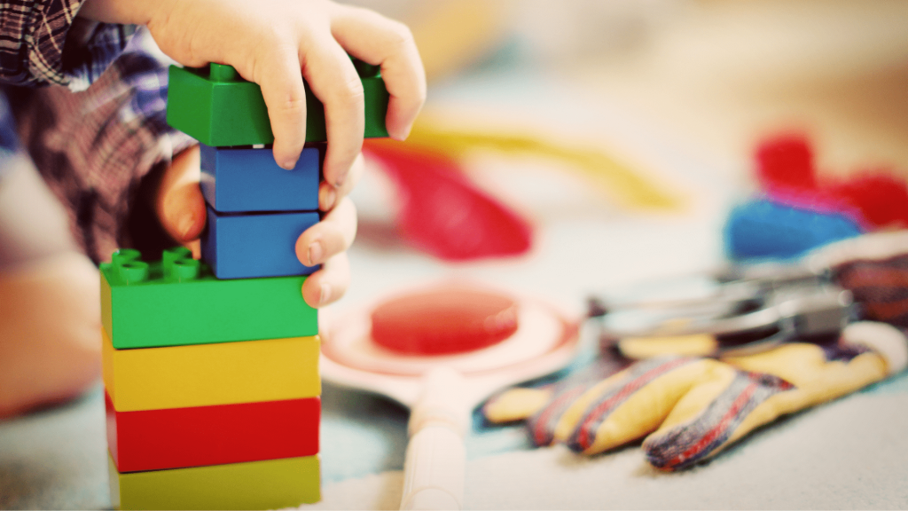 Kids Inc Celebrate Children’s Mental Health Week | Kids Inc Nurseries Close up of child playing with blocks